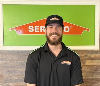 photo of male employee in front of Servpro Sign